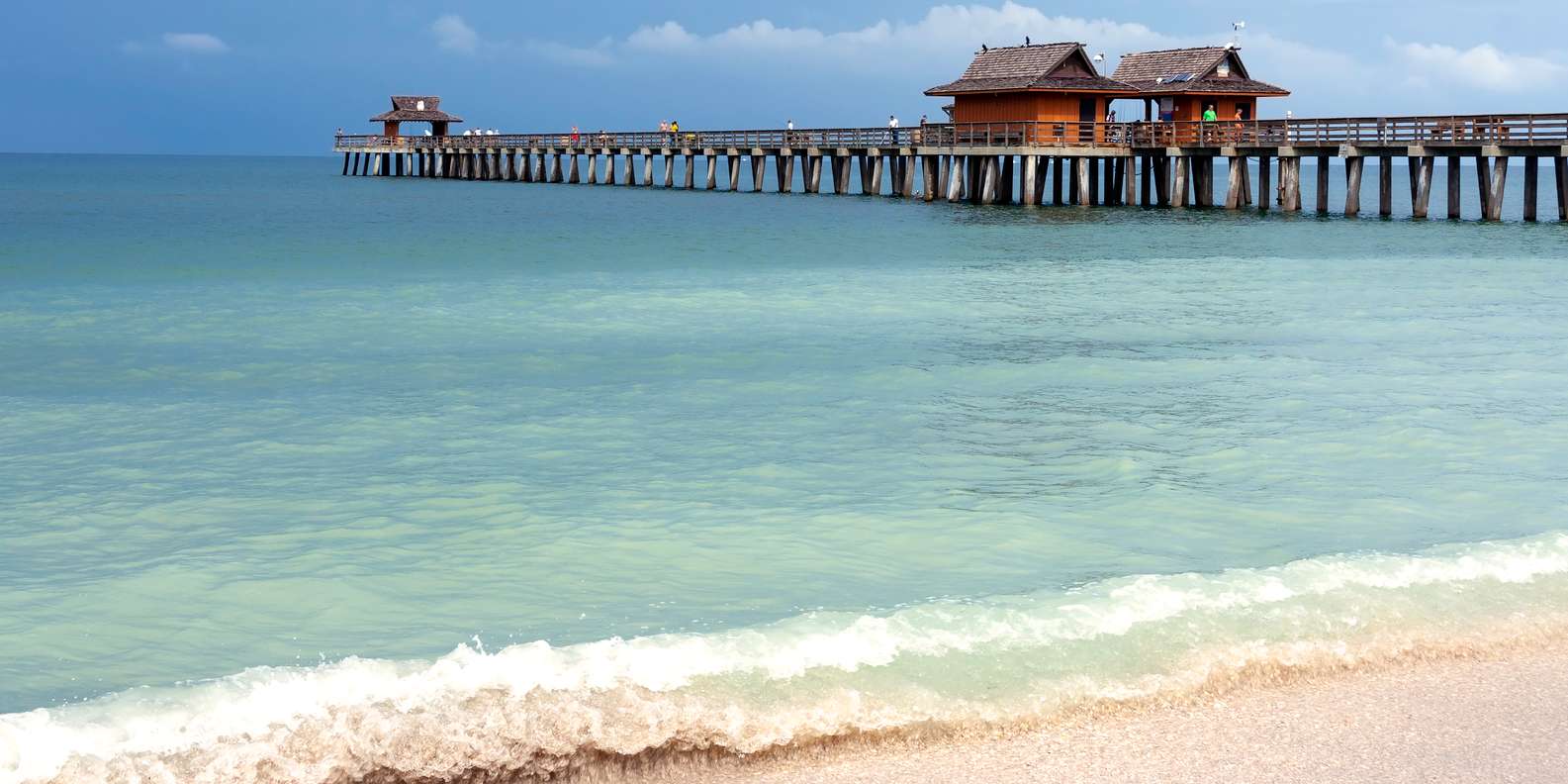 Sunset view of the Naples Pier stretching into the Gulf of Mexico